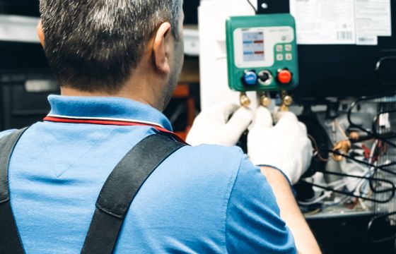 Technician working on an HVAC system indoors