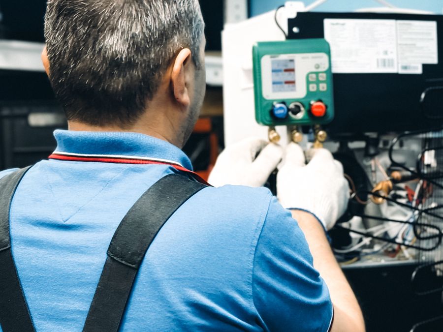 HVAC technician working on air conditioning equipment