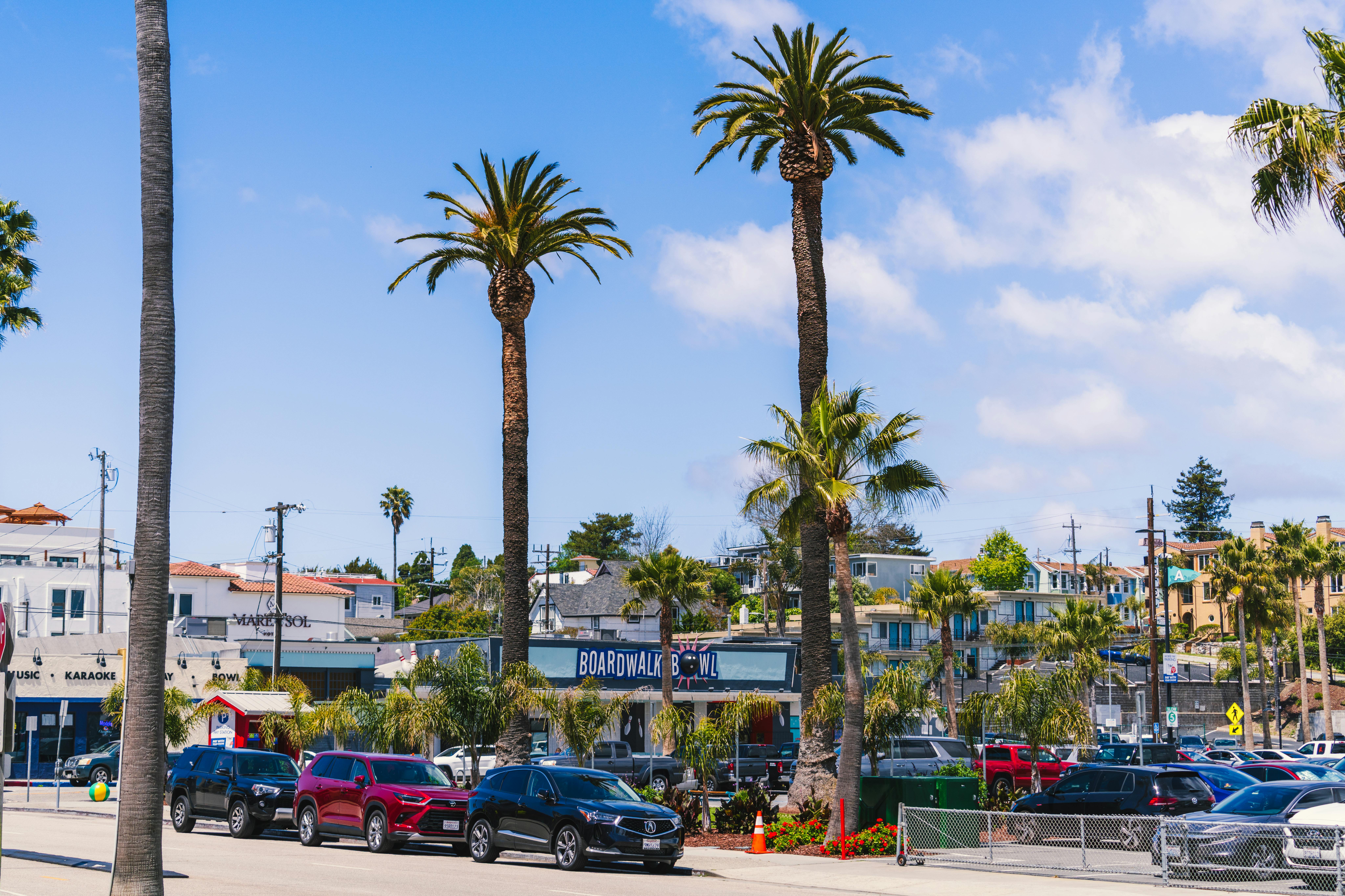 Experience the lively atmosphere of Santa Cruz Beach Boardwalk on a sunny day.