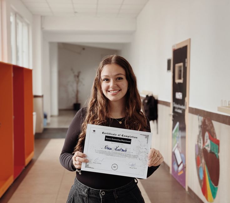 navigating career plateaus with digital education - Smiling woman proudly displays certificate in a school corridor. Achievement and success captured.