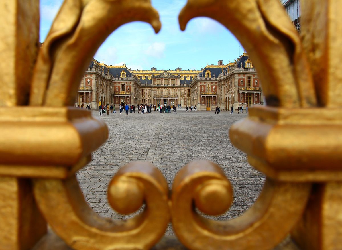 The Palace of Versailles facade seen through its gilded gate