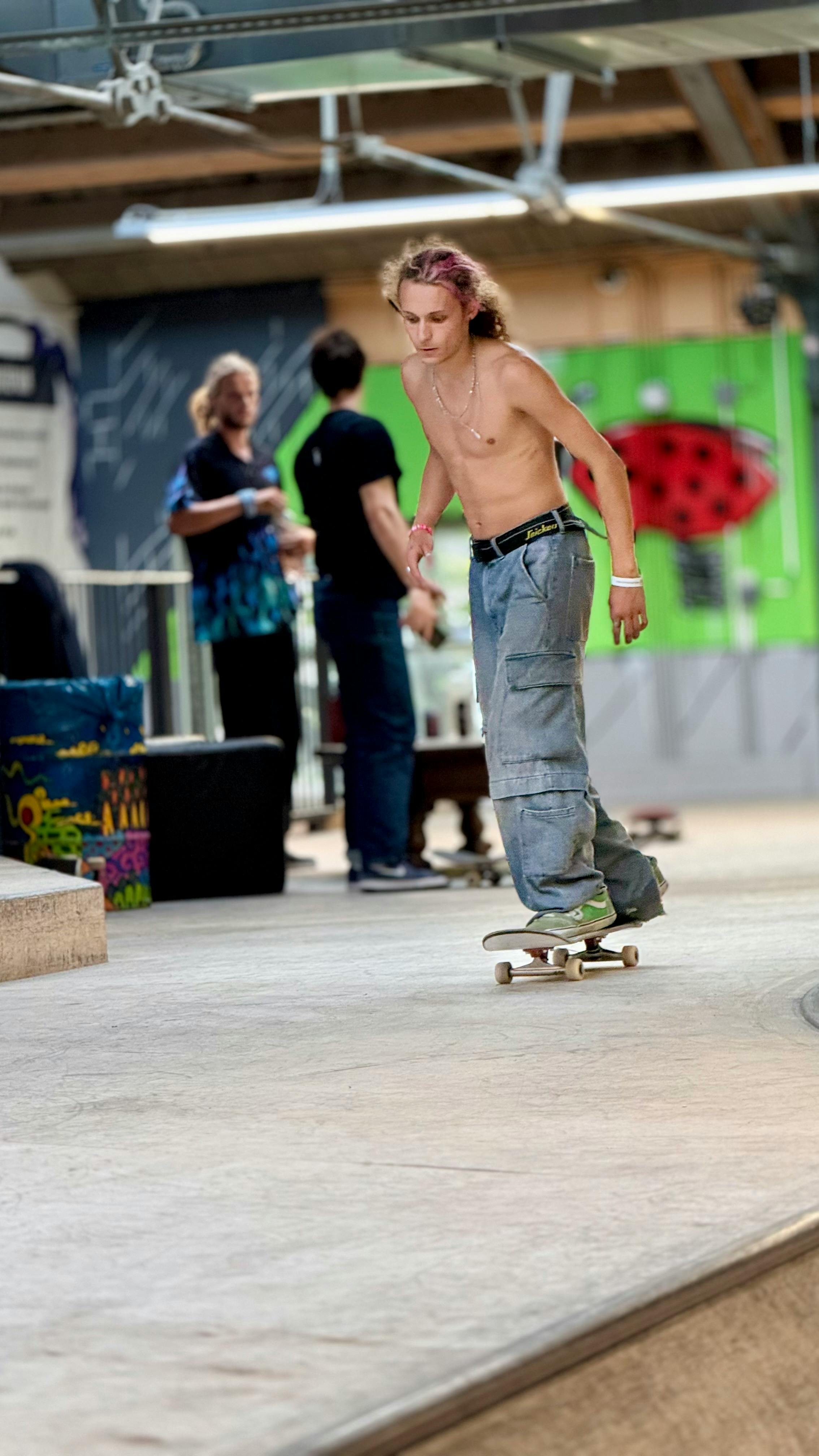 Young skater honing skills at an indoor skatepark. Dynamic and energetic atmosphere.