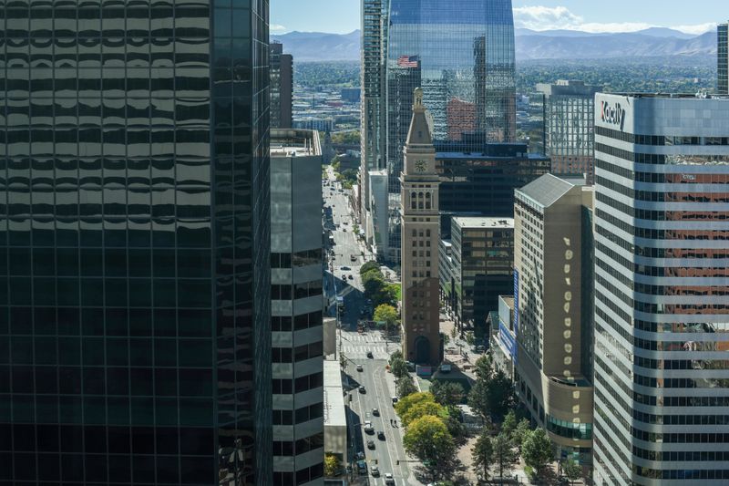 Aerial view of downtown Denver showing the iconic clock tower amidst modern skyscrapers