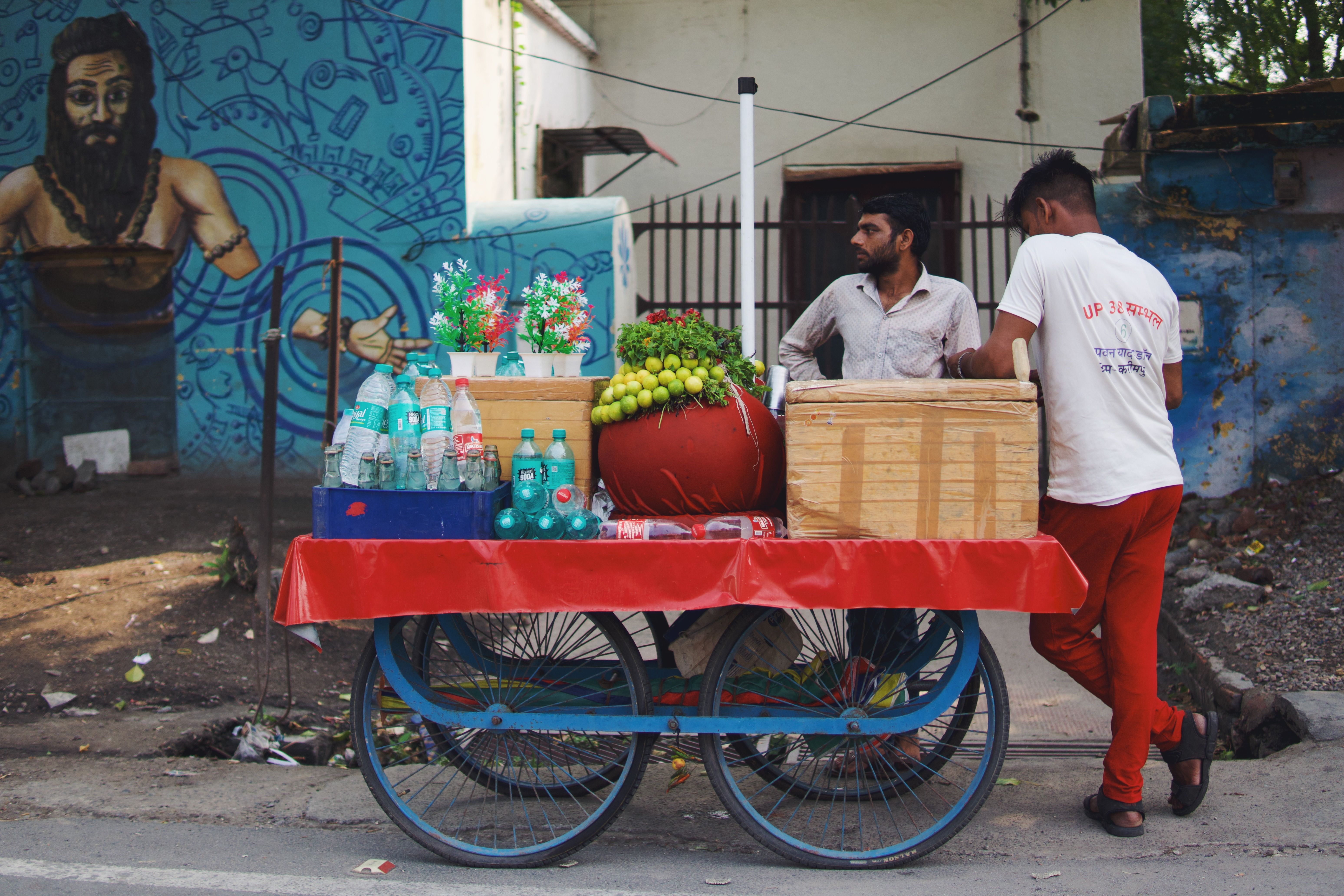 A reusable water bottle on a vibrant street food stall in India, emphasizing sustainable hydration