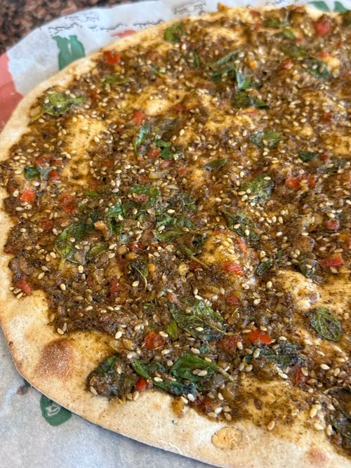 Free Delicious za'atar flatbread with herbs and sesame seeds, freshly baked. Stock Photo