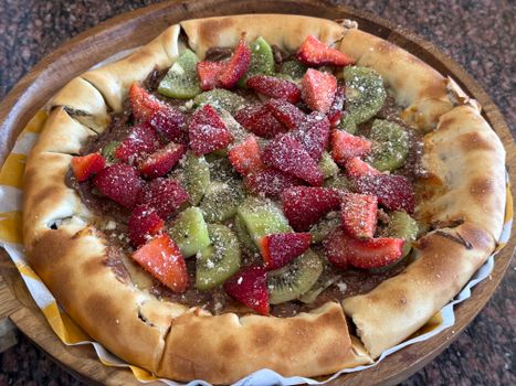 Thick Crust Pizza With Meat And Fruit