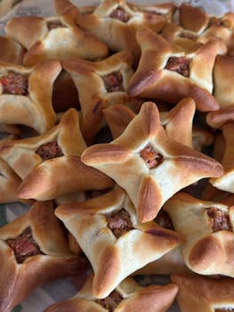 Golden-brown meat pastries piled together, fresh and appetizing.