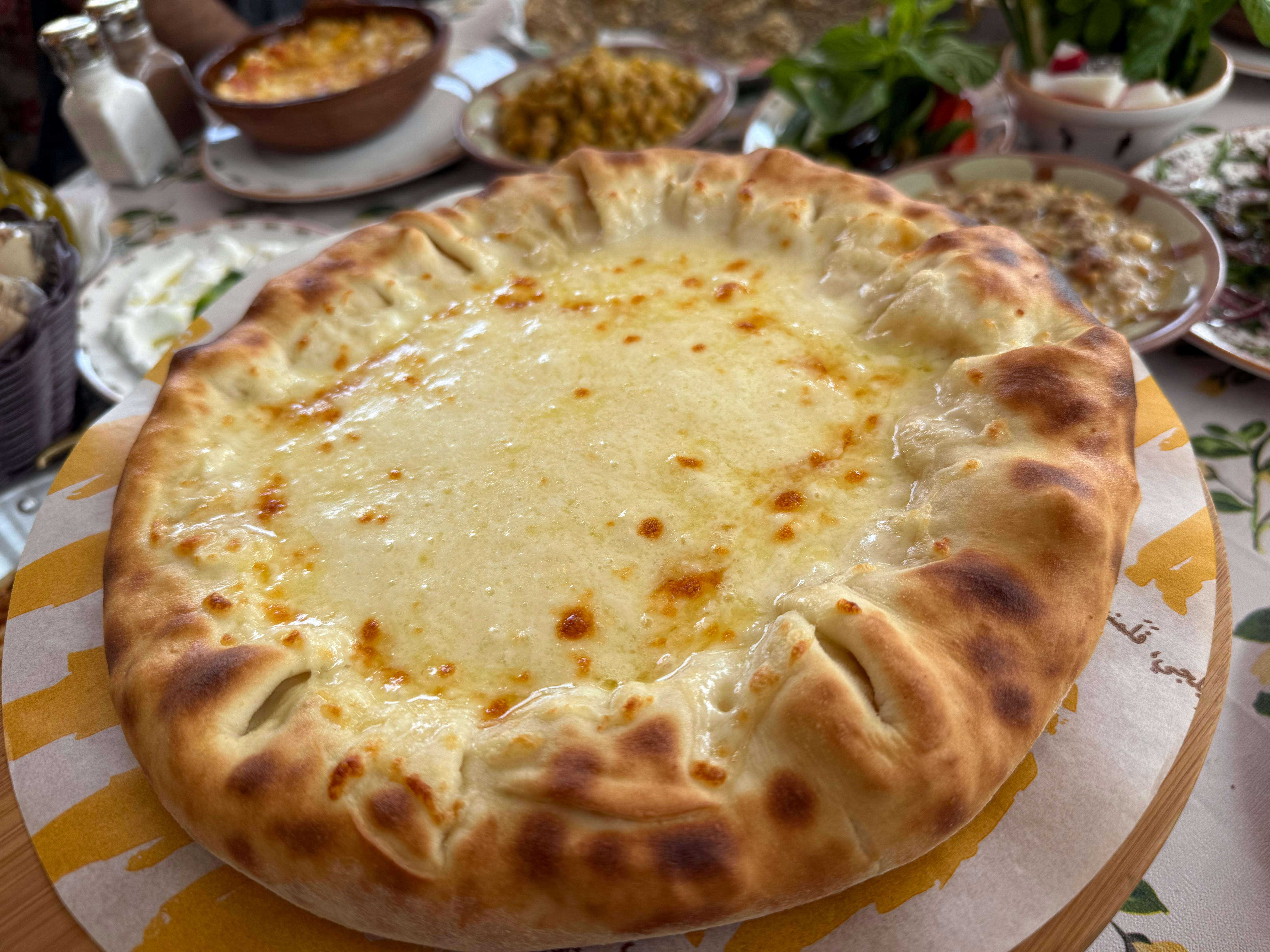 A traditional Mingrelian feast with khachapuri and local wine - economical Georgia Black Sea