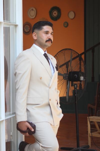 Man in a cream vintage suit gazing thoughtfully — fatih kilic on Pexels