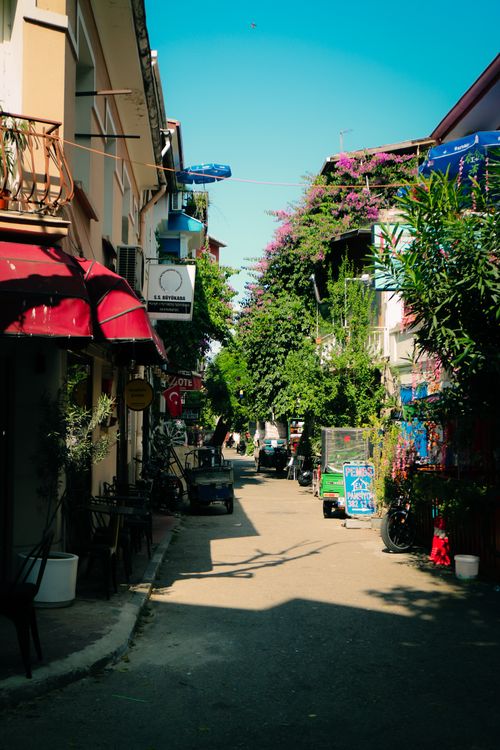 Free Picturesque street in a Mediterranean town with colorful buildings and lush greenery. Stock Photo