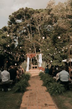 Beautiful outdoor wedding ceremony setup with string lights and natural decor.