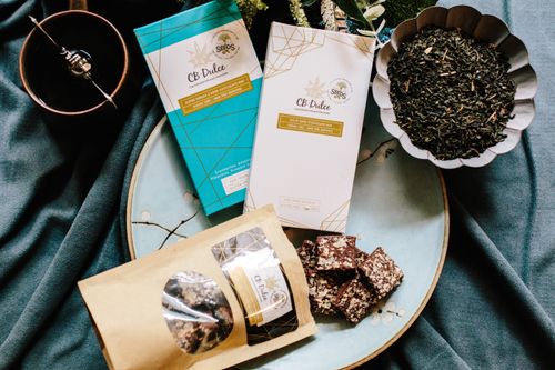 Free Flat lay of CBD Dulce dark chocolate bars and ingredients on a table setting. Stock Photo