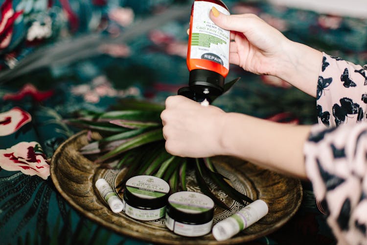 Woman Putting Lotion On Her Hand