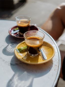Two espressos on colorful saucers at a Paris cafe, capturing a typical leisurely morning.