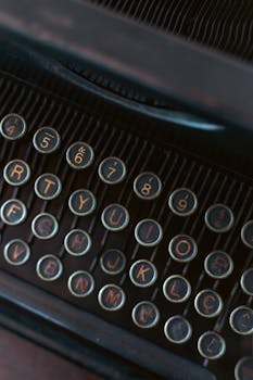 Focused shot of antique typewriter keys displaying letters and numbers.