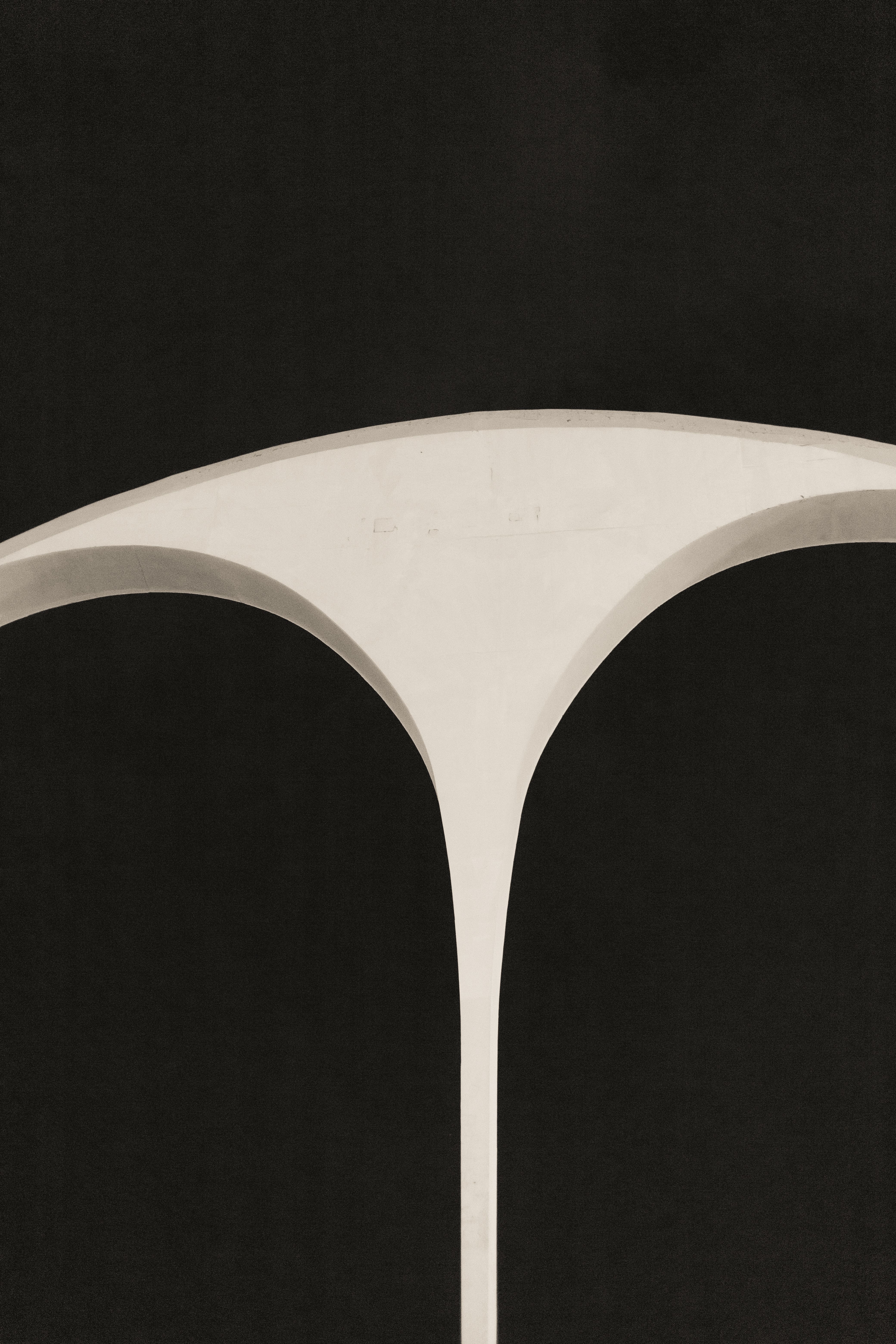 Minimalist architectural structure with a dark background, evoking a modern aesthetic.