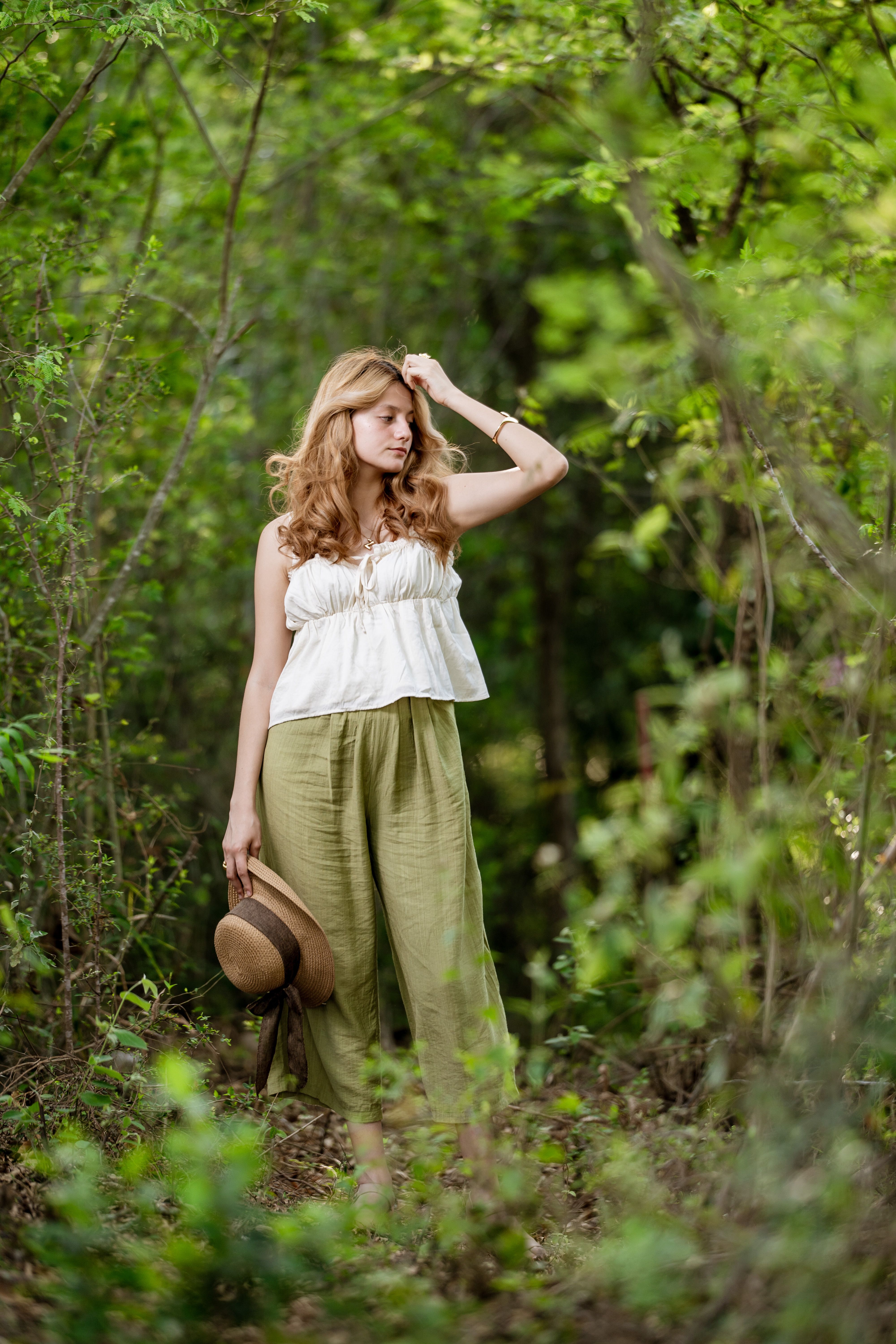Woman Strolling through Green Forest Clearing · Free Stock Photo