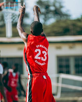 Player shooting basketball outdoors in Bujumbura, Burundi. Exciting sports action.