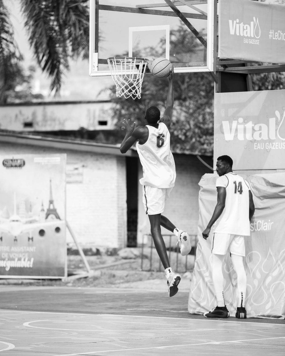Dramatic black and white photo of an intense street basketball moment