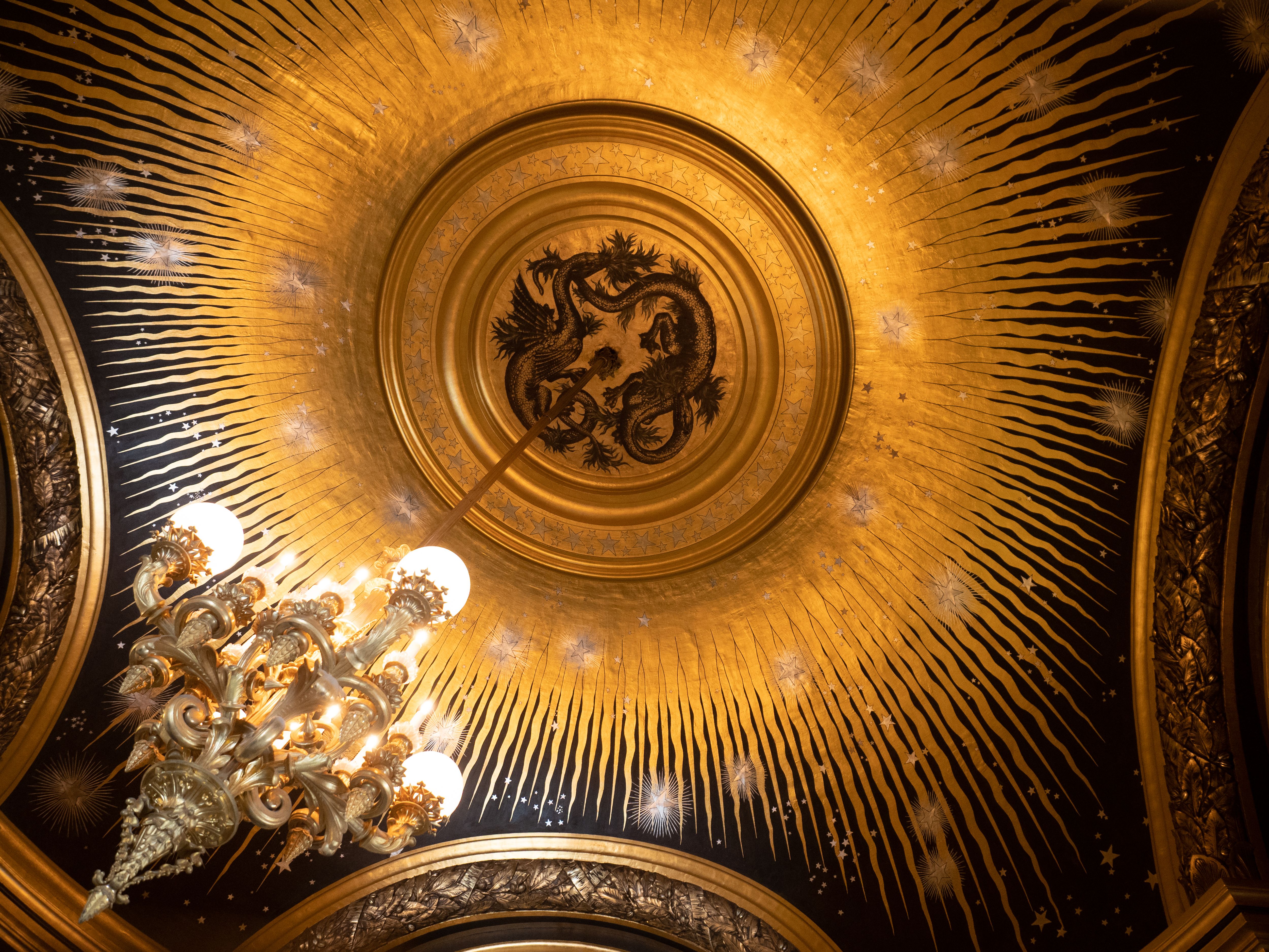 Painted ceiling and chandelier in a converted Lisbon palace salon
