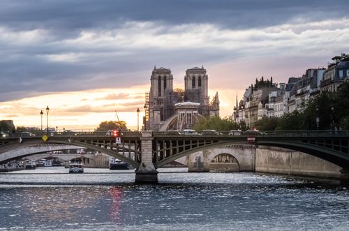 Free Scenic sunset view of Notre Dame Cathedral and Seine River in Paris, France. Stock Photo
