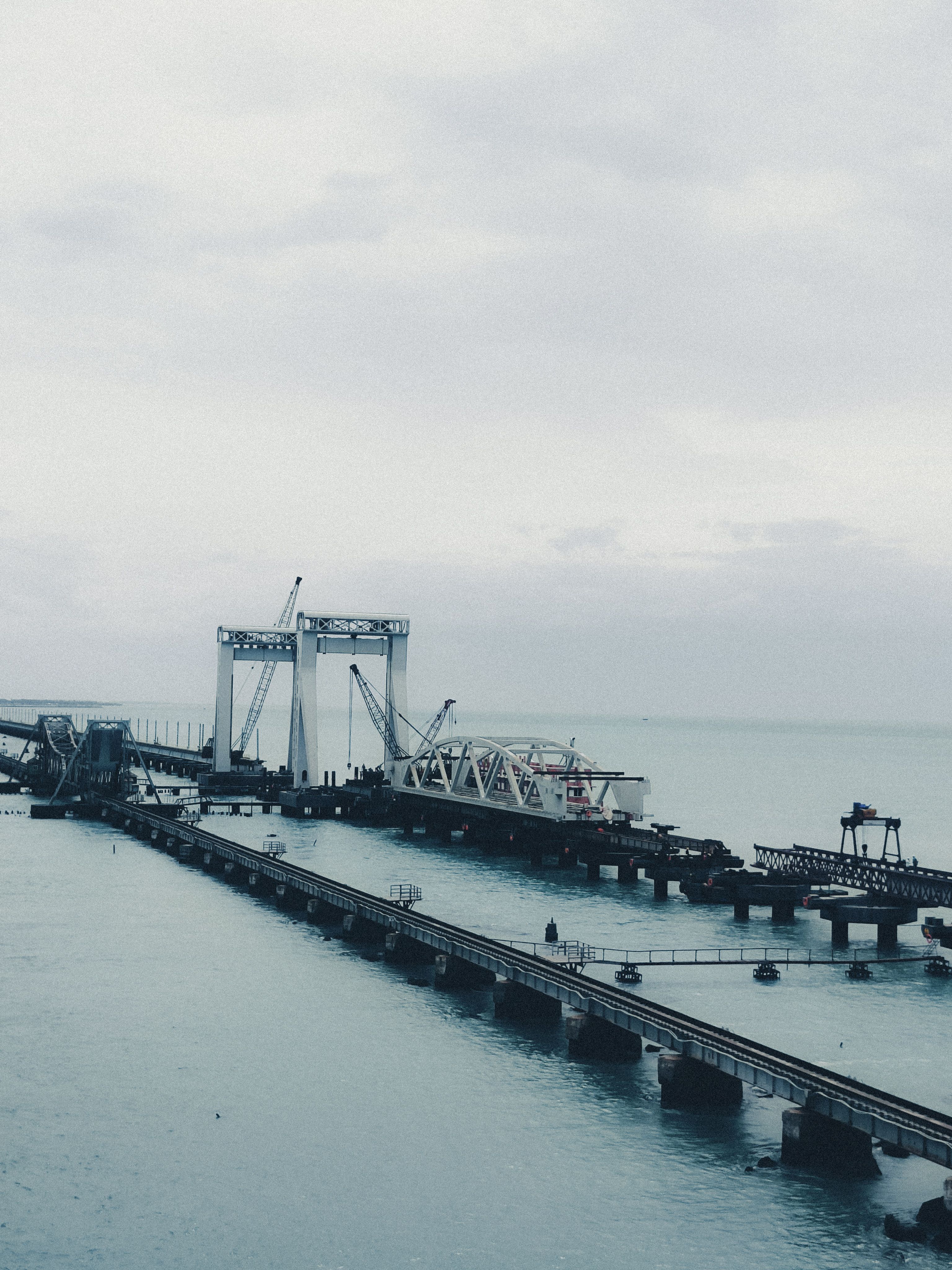 A scenic view of Pamban Bridge on a cloudy day in Rameshwaram, Tamil Nadu, India.