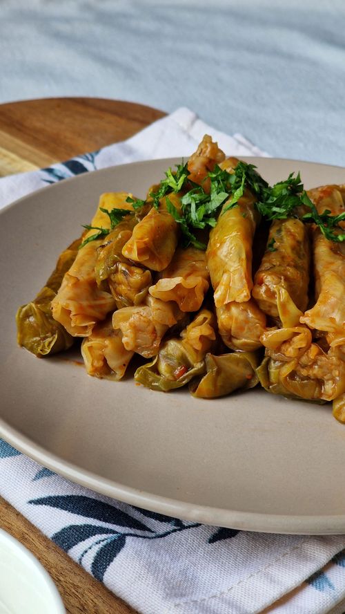 Free Delicious homemade stuffed cabbage rolls garnished with fresh herbs. Stock Photo