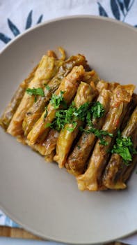 Deliciously cooked stuffed cabbage rolls garnished with fresh parsley on a plate.