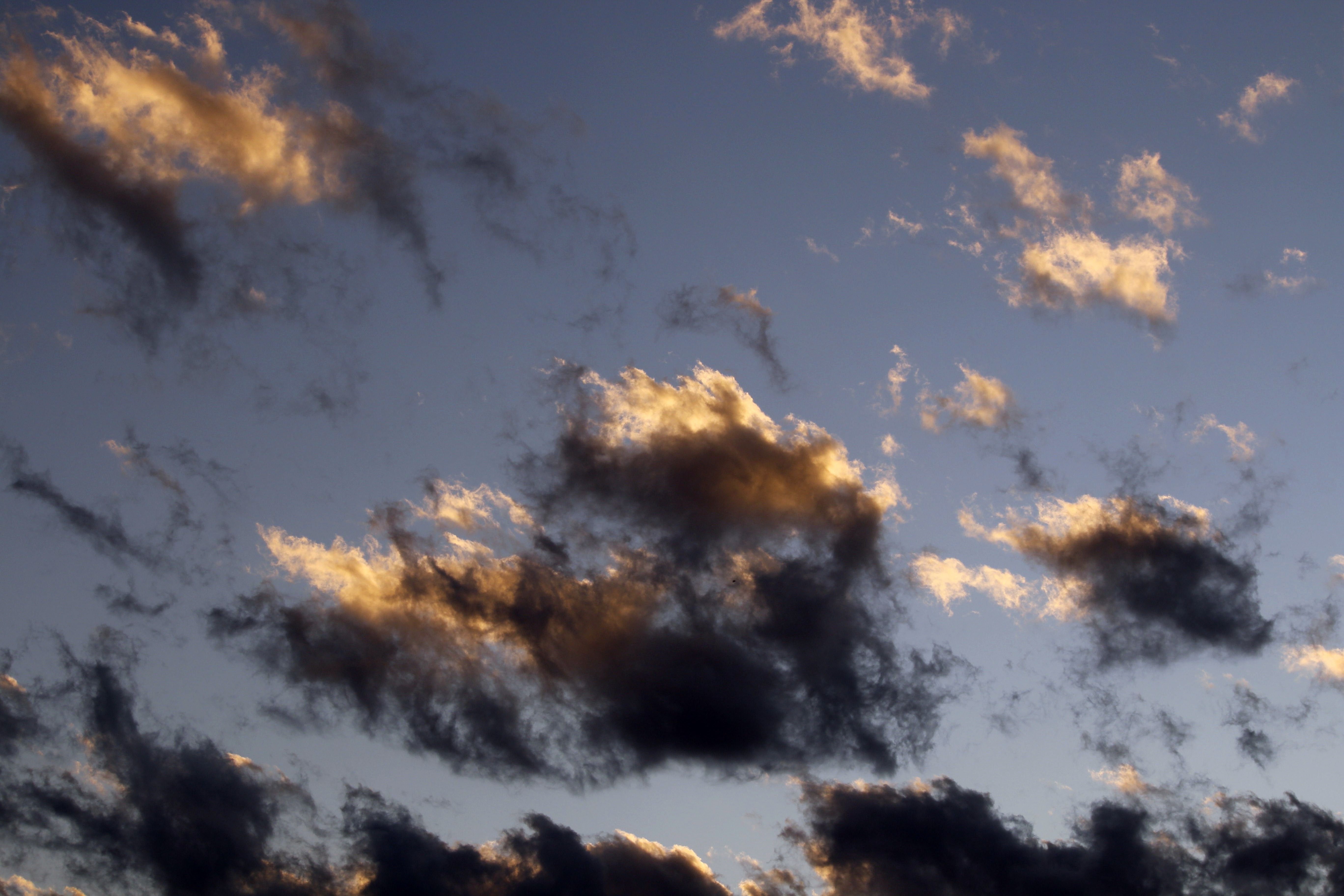Golden and dark clouds at sunset in Guaratuba, Paraná, creating a dramatic sky.