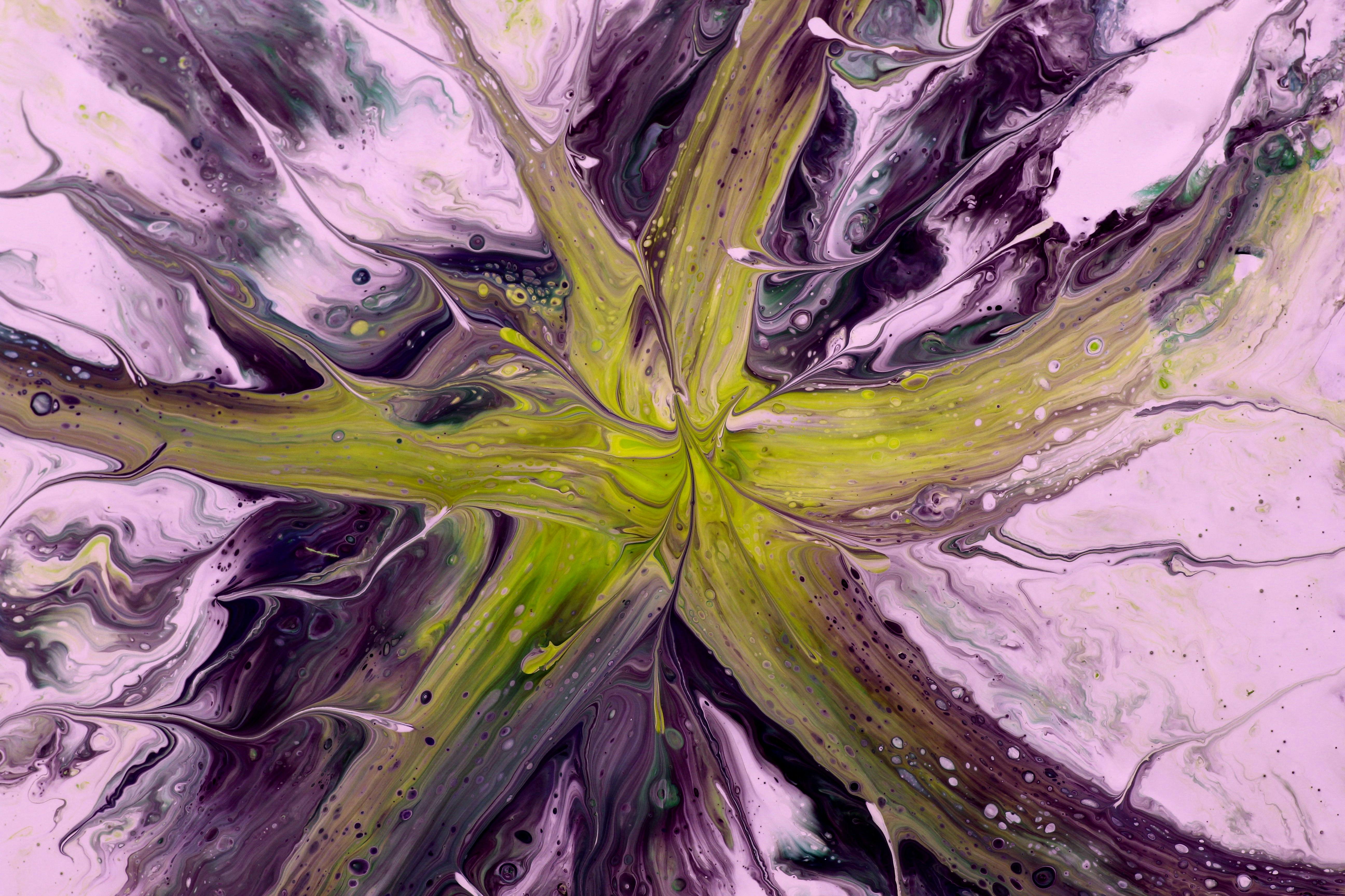 Vibrant abstract artwork depicting fluid patterns in purple, pink, and green hues, resembling a cosmic explosion.