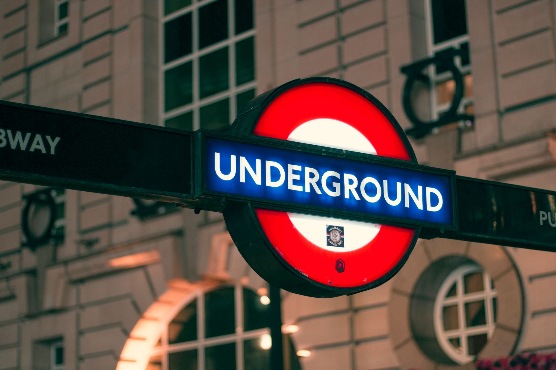 대구 더현대 주토피아 팝업 3 Close-up of the London Underground sign illuminated at night, highlighting a famous transport symbol.