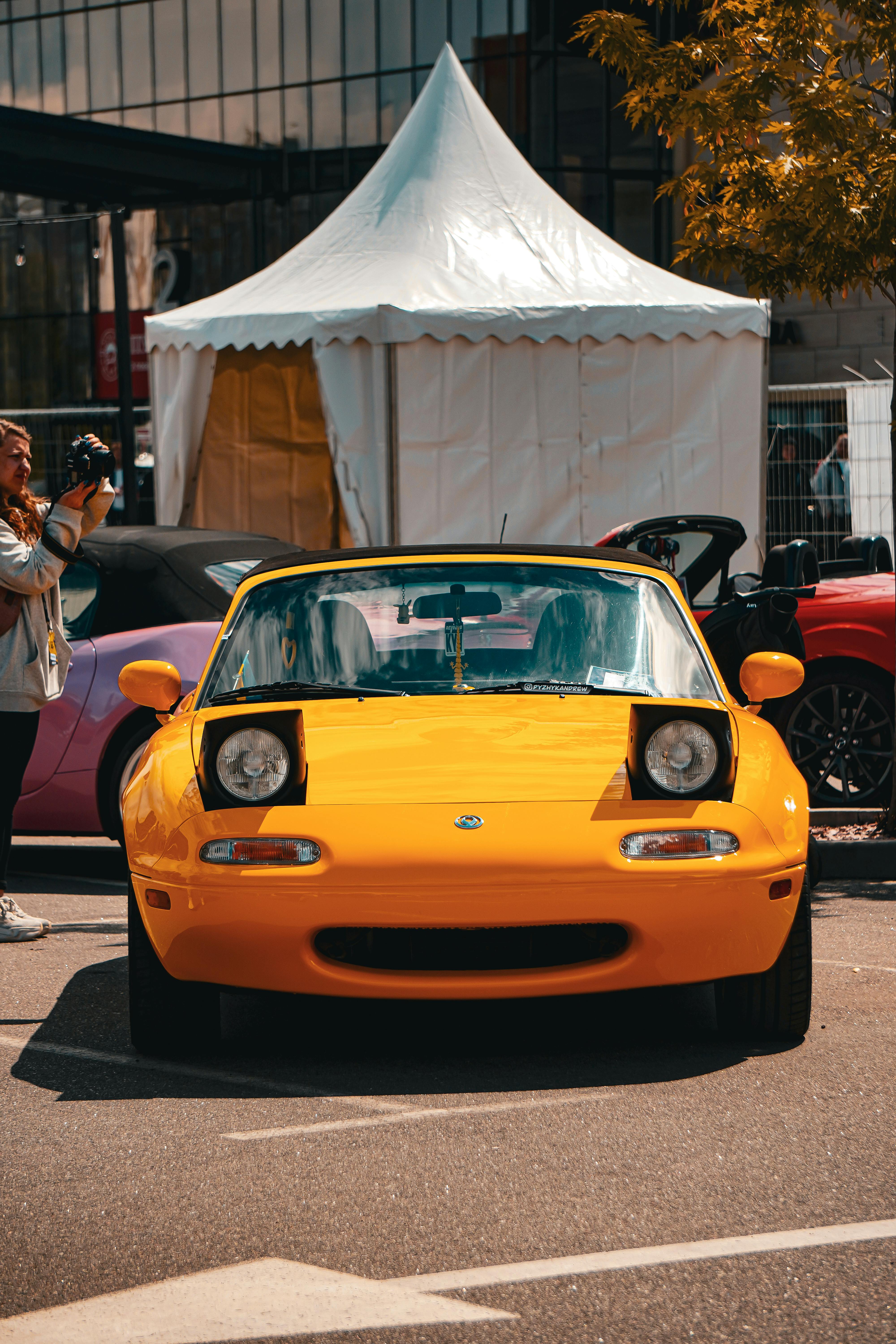 Close-up of a yellow sports car at a car show in Kyiv, Ukraine during summer.