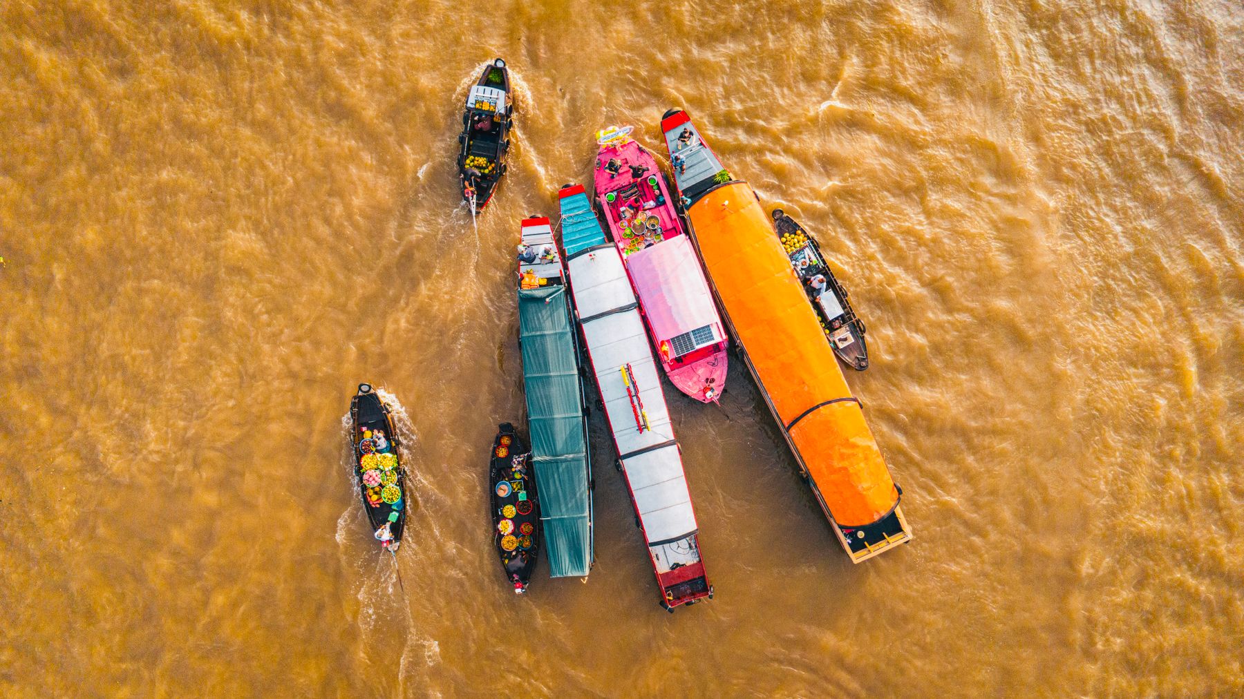 Colorful traditional boats at CΓ‘i RΔng Floating Market in CαΊ§n ThΖ‘, Vietnam.