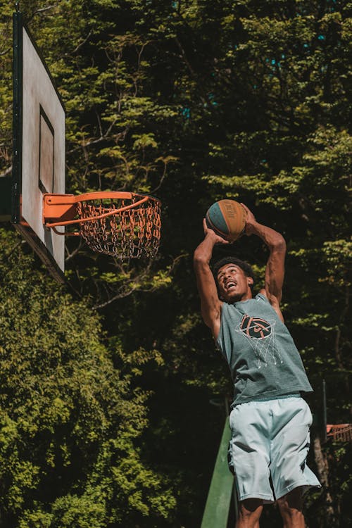Free Man Going to Dunk on Hoop Stock Photo