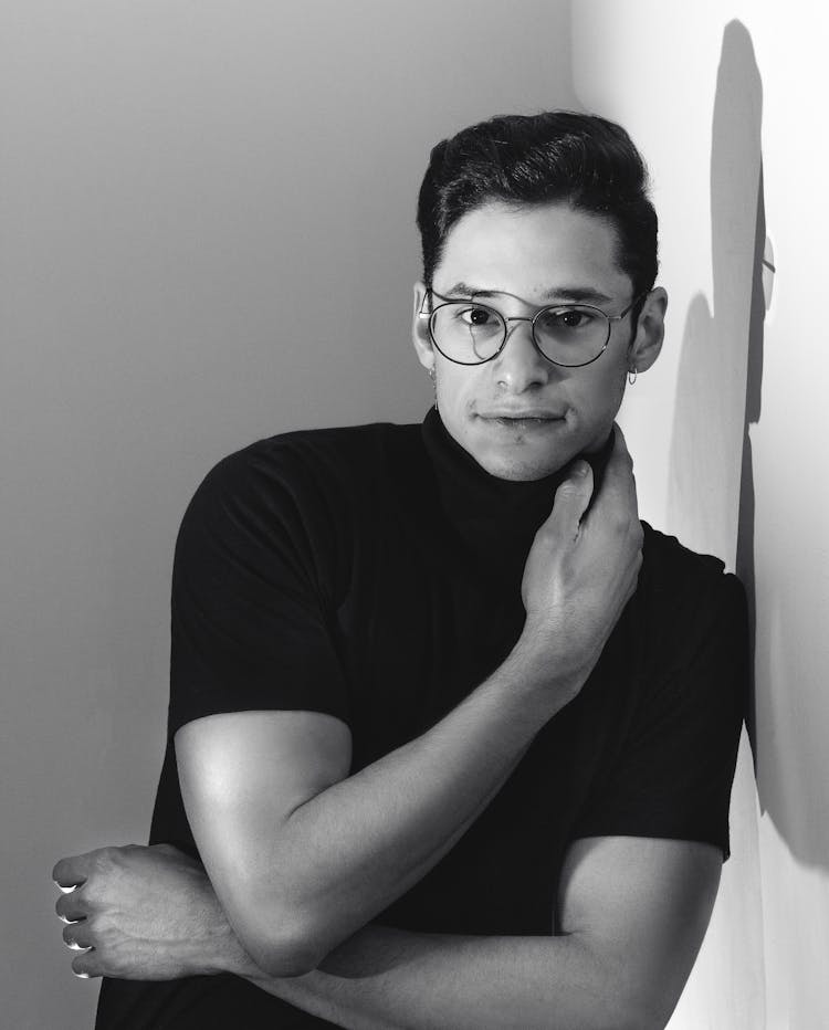 Grayscale Photography Of Man Leaning On Wall