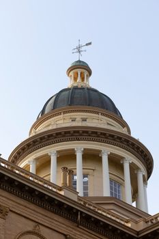 Close-up of a classic courthouse dome with columns and weather vane.