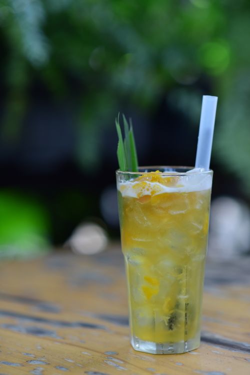 Free Refreshing iced tropical fruit drink served in a tall glass, perfect for summer days. Stock Photo