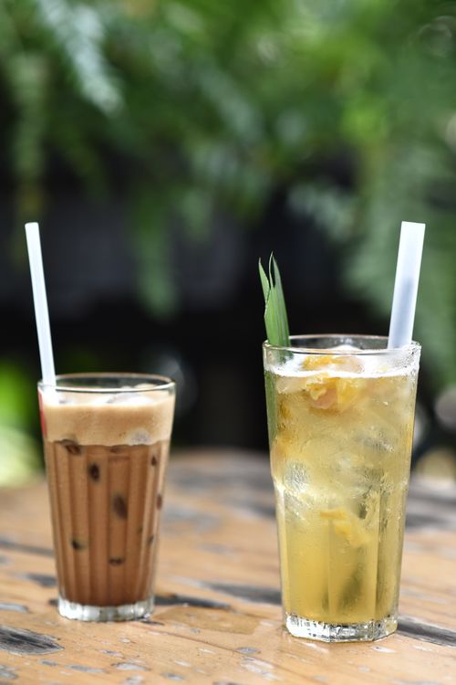 Free Two refreshing drinks, iced coffee and herbal tea, served on an outdoor table. Stock Photo