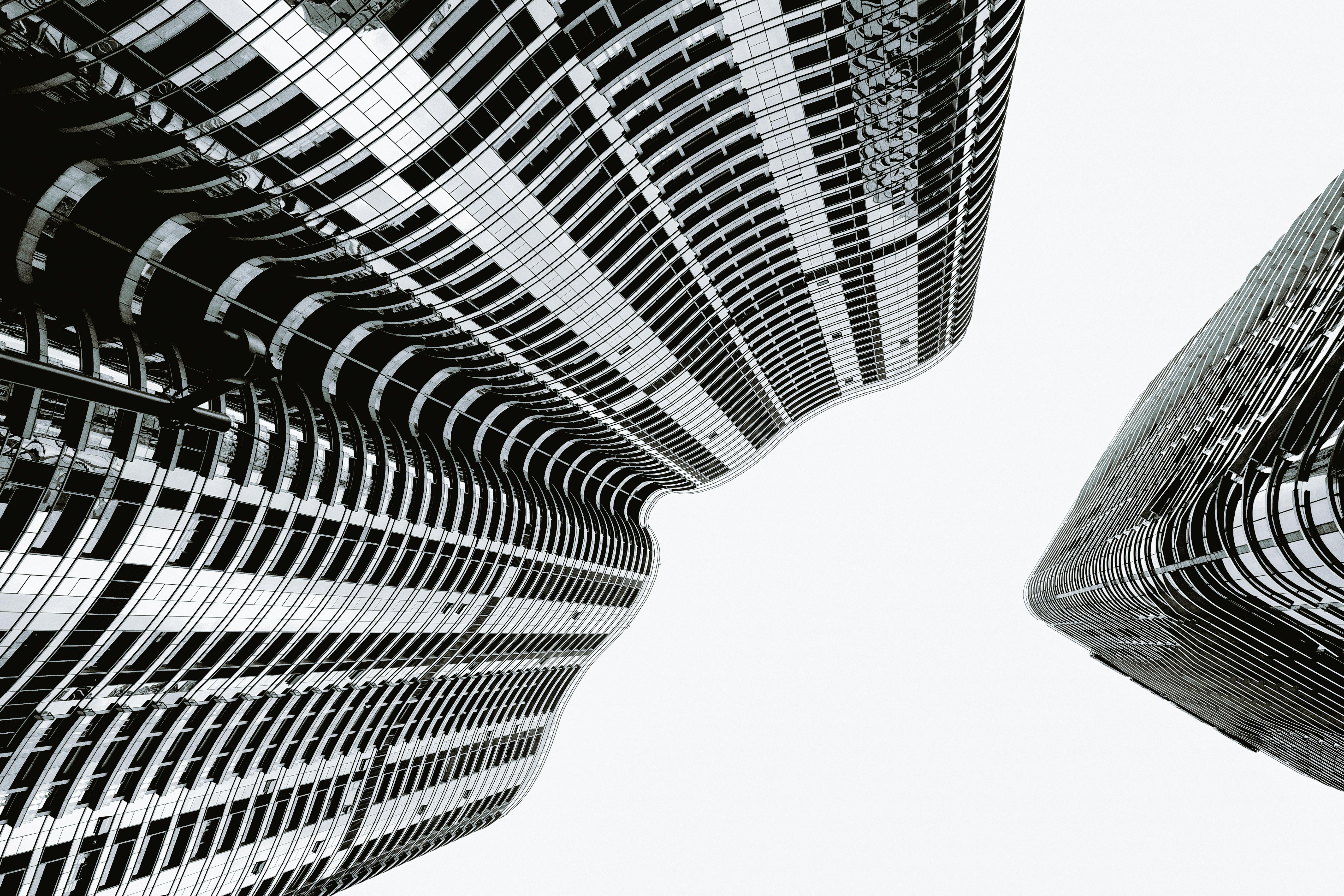 Artistic black and white view of modern skyscrapers with a dynamic twist.