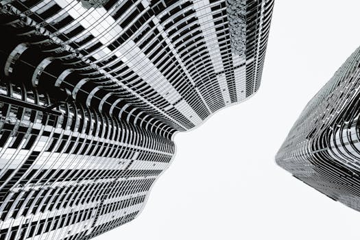 Artistic black and white view of modern skyscrapers with a dynamic twist.