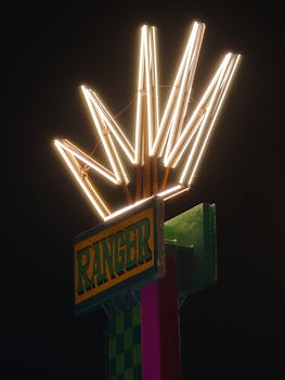 Illuminated Ranger sign with bold neon lights against a dark night sky.