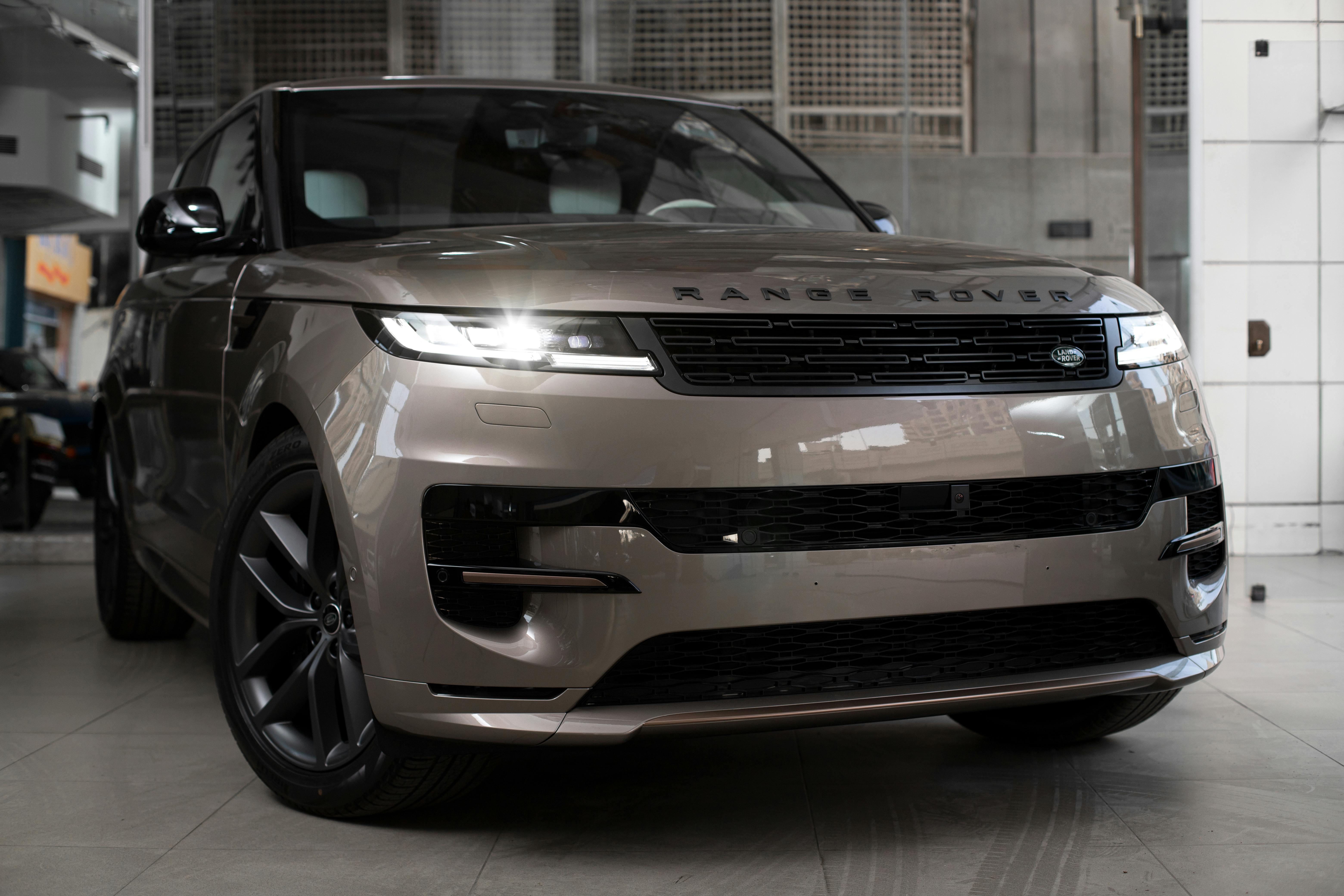 A range rover sport is parked in a garage.