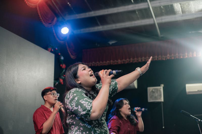 Vocal group performing on stage with energy and choreography
