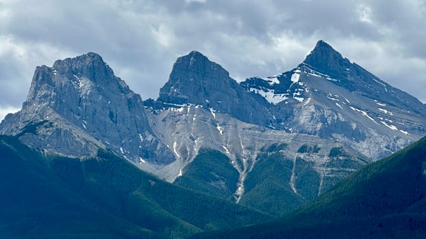 Breathtaking view of the iconic Three Sisters peaks in the Canadian Rockies, Alberta.