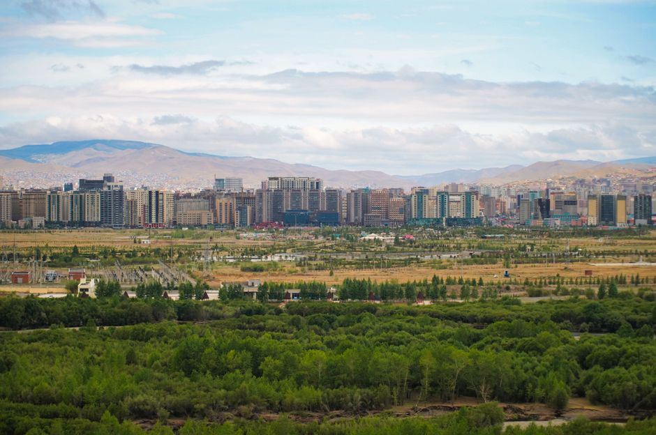 Panoramic view of Ulaanbaatar with greenery and mountains in Mongolia.