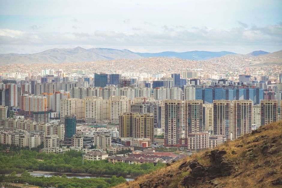 Explore the urban skyline of Ulaanbaatar, Mongolia with mountains in the backdrop.