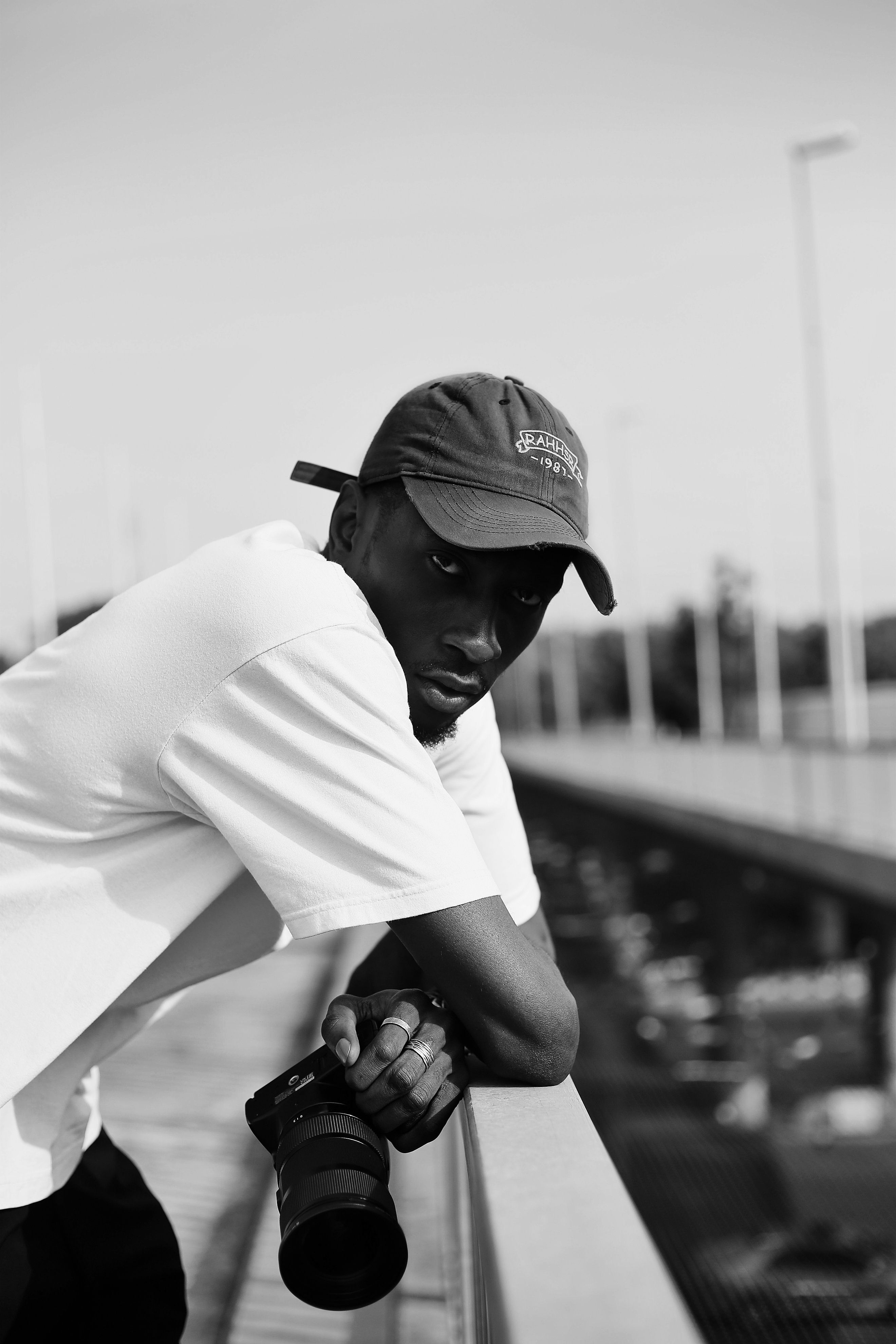 Stylish black and white portrait of male photographer in Abuja, Nigeria.