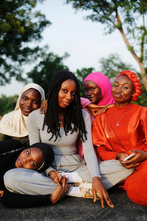 Free Joyful group portrait of diverse women sharing a moment outdoors in Abuja, Nigeria. Stock Photo