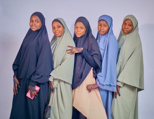 Free Five women wearing traditional hijabs posing together in a studio setting. Stock Photo