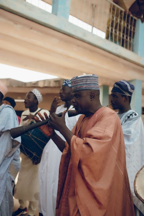 Free Group of musicians performing with traditional African instruments at an outdoor event. Stock Photo